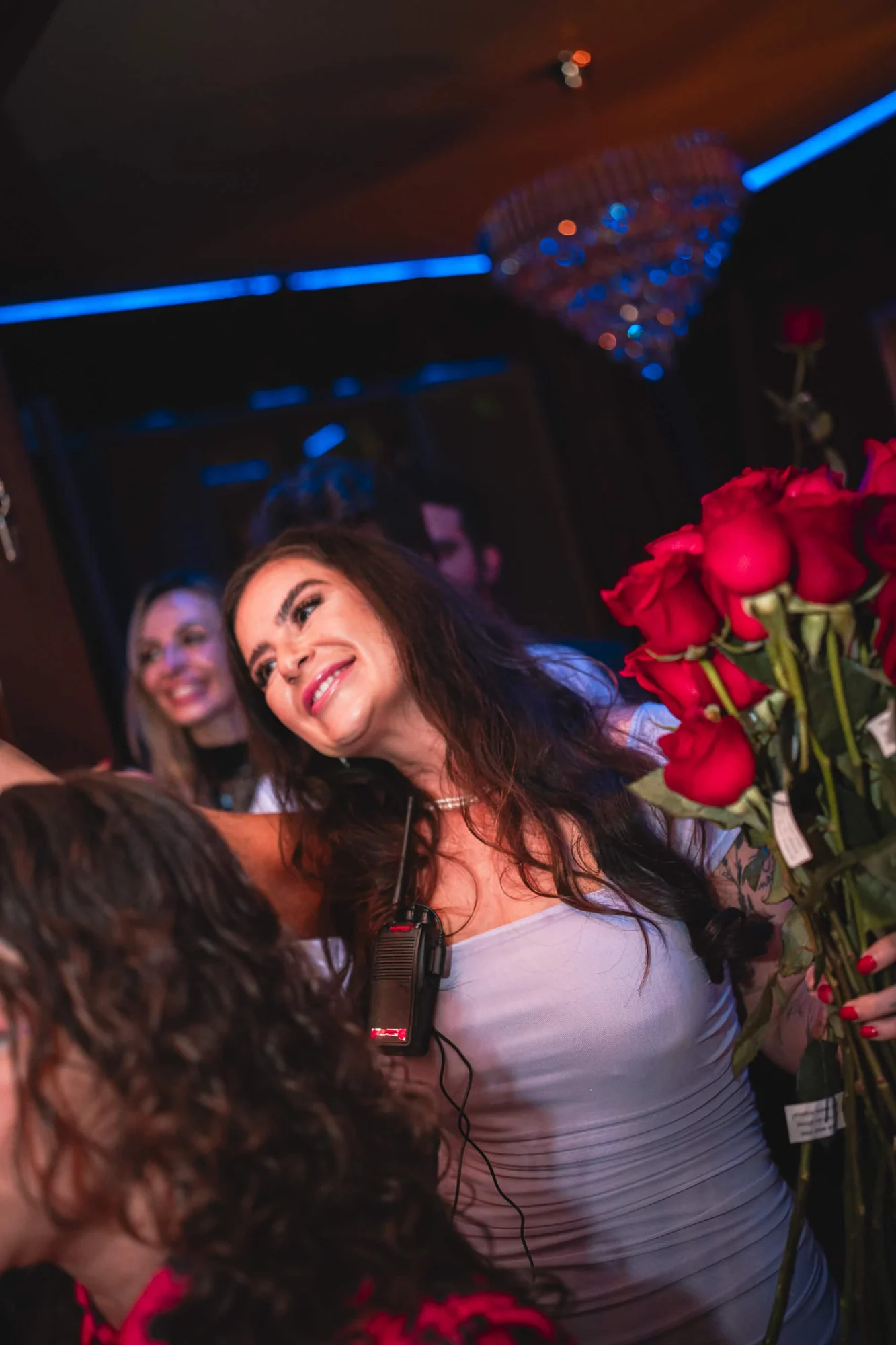 Guest receiving flowers during a celebration at Cabaret Le Luxe