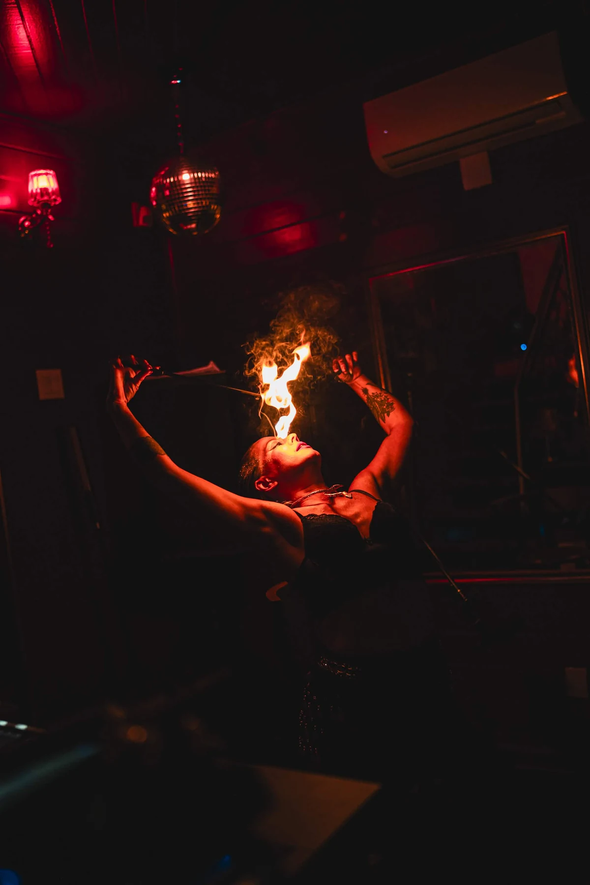 Artist performing with fire at Cabaret Le Luxe